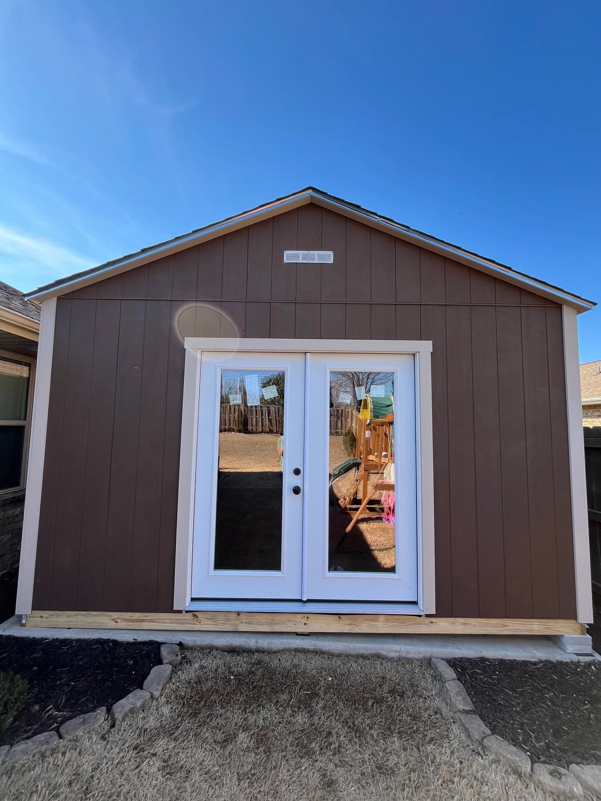 Brown Southern Shed Co. shed with full-glass French doors